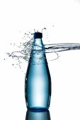 A splash hitting a bottle of water