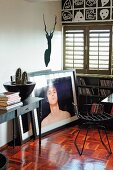 Vintage metal chair in corner of room with closed window shutters