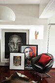 Black, leather swivel chair in front of collection of pictures and portrait of Obama