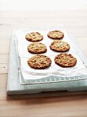 Anzac biscuits on a baking-paper covered wirerack