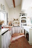 Kitchen-dining room with terracotta floor tiles in Mediterranean country house
