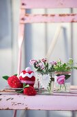 Fruits and cakes hand-crafted from scraps of felt, red socks and jersey next to preserving jars decorated with heart and fabric rose