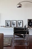 Zwei Wassily Stühle im Wohnraum vor Wandbord mit Schwarzweiss-Fotografien