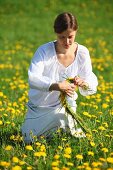 Woman making dandelion wreath