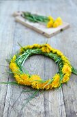 Dandelion wreath on a wooden surface