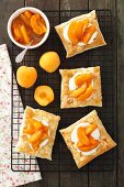 Puff pastry tartlets with yoghurt and lime cream and apricots