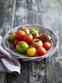 Various types of tomatoes in a wicker basket