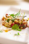 Bean salad with onions, parsley, fennel and cherry tomatoes