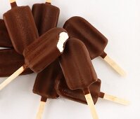 Several ice lollies with chocolate coating (view from above)