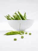 Peas and pea pods in a bowl