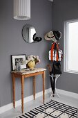 Cloakroom in cool black, white and grey colour scheme relieved by vintage-effect console table