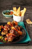 Pork skewers with bacon and dried apricots