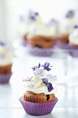 Heidelbeer-Cupcake mit Zuckerblumen und Veilchen