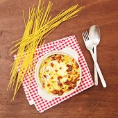 Spaghetti with sweetcorn, topped with cheese sauce and baked