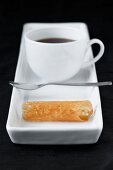 cup pof coffee with small brandy snap tuille