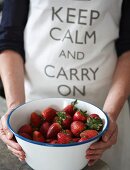 Fresh strawberries and an apron with a logo