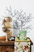 Dried puffer fish under glass cover and ceramic mug on rustic wooden table, stylised coral artwork on wall