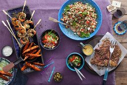 Assorted barbecued dishes with salad accompaniments