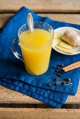 Pineapple and ginger punch with spices in a glass mug