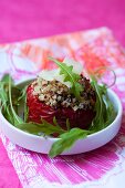A red pepper stuffed with quinoa, with parmesan and rocket