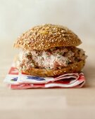 A wholemeal bread roll with a blended tomato and cheese filling