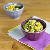 Grilled Corn Salad with Cucumbers in a Purple Bowl