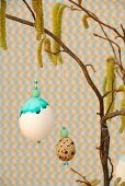 Painted eggs hanging from hazel branch