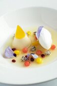 Exotic fruit salad with a quenelle of quark and pansies