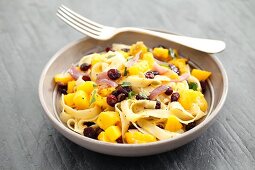 Tagliatelle with pumpkin, cranberries and parsley