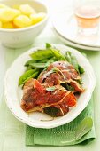 Saltimbocca with sugar snap peas and boiled potatoes