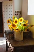 Vase of sunflowers on wooden console table in foyer