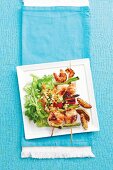 Fish skewers with prawns and vegetables, served with an Asian carrot salad