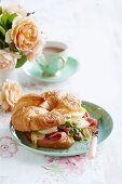 Croissant filled with ham, egg and melted cheese