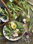 A plate of raw vegetables and sugar snap peas