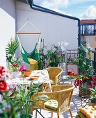 A balcony with furniture and green plants