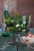 Salted cucumbers in glass jar with garlic and pink salt