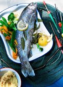 Poached trout with buttered vegetables and pine nut polenta