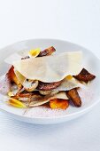 An open lasagne with dahlia foam and fried mushrooms