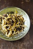 Radish Spätzle (soft egg noodles from Swabia) with chrysanthemum petals and wood ear mushrooms