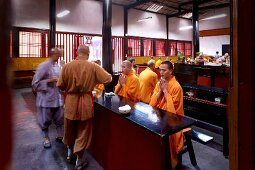 Monks sitting at a dining table