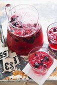 Berry drink in a jug and in two glasses
