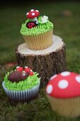 Cupcakes decorated with a ladybird, as a toadstool and with a hedgehog