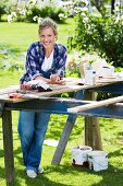 Portrait of a woman doing carpentry in a garden, Sweden