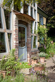 Planters outside rustic house with brick facade