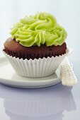 A chocolate cupcake topped with matcha buttercream