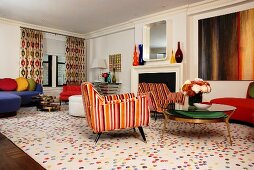 Colourful living room with open fireplace and retro mirror on chimney breast