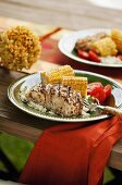 Grilled halibut with corn cobs and tomatoes