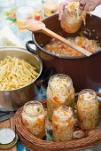 White cabbage and carrot salad with red peppers in jars