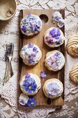 Candied Pansy and Viola Mini Pavlovas on a Wooden Board From Above