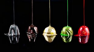 Chocolate truffles being drizzled with colors of nail polish